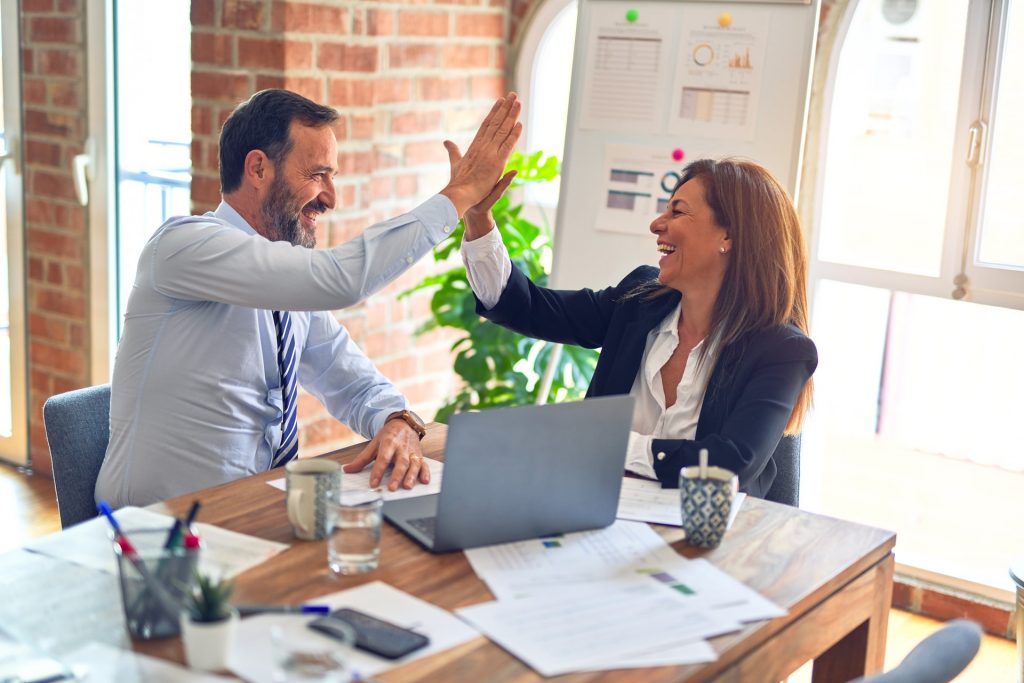 small business employees high fiving